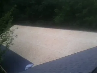 New OSB roof sheathing installed beside an existing shingle roof in Mont Alto