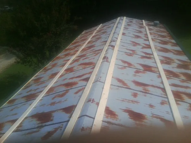 Rusted metal roof panels with new wood purlins before replacement — Storm Damage Roof Repair in Mont Alto by Roofing Brothers