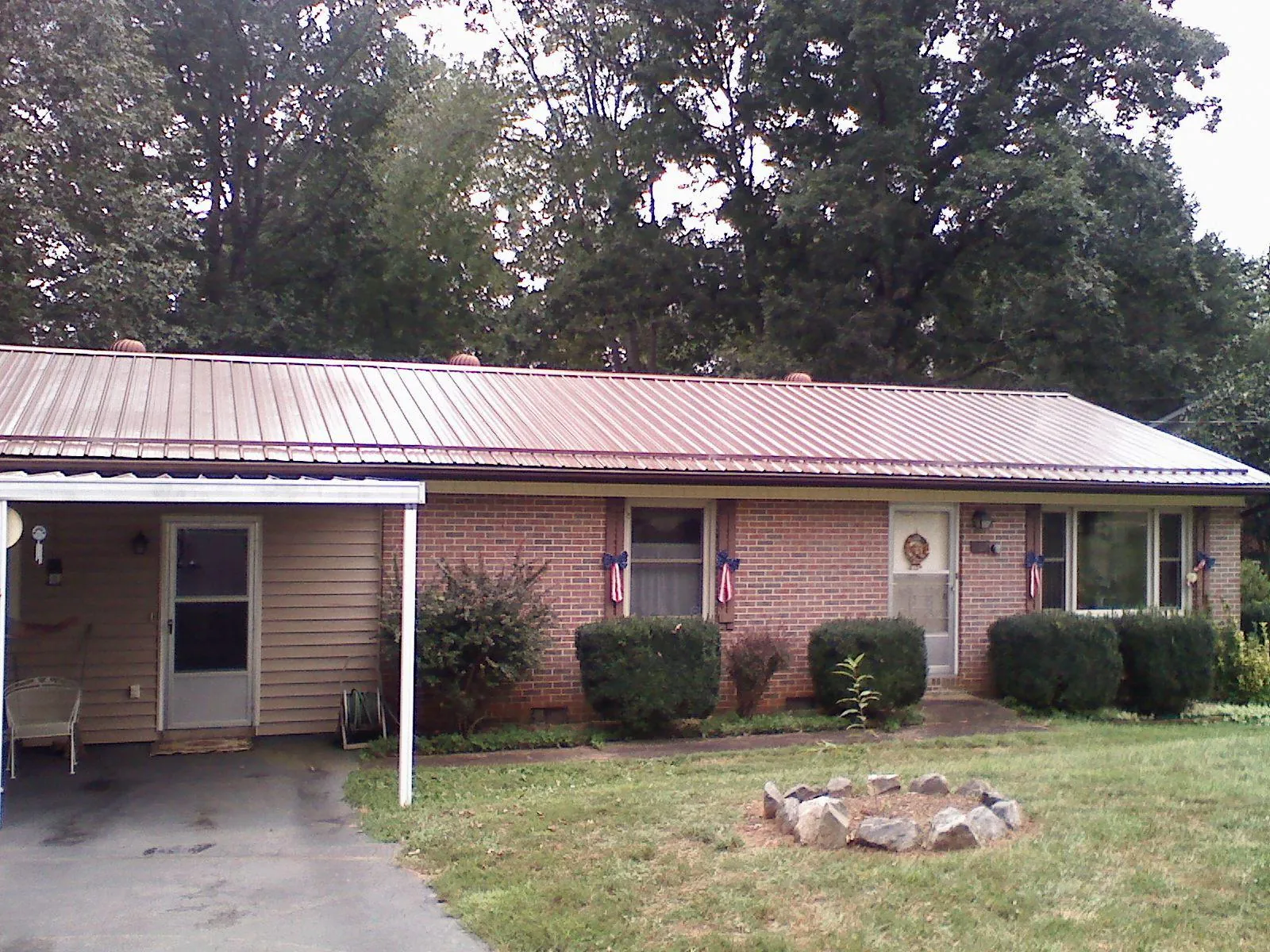 Bronze metal roof and carport on a brick ranch home — Roof Repair work by our crew in Mont Alto