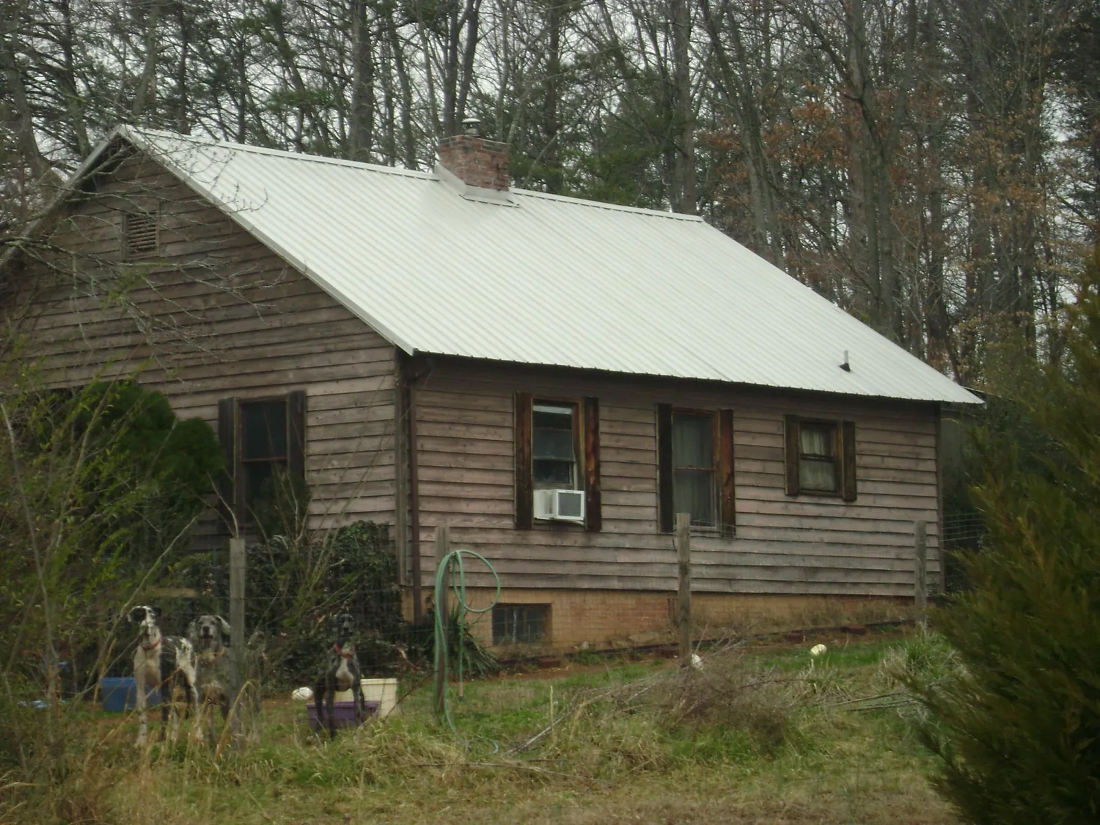 White metal roof on an old wood sided farmhouse, from a Metal Roof Installation job in Mont Alto